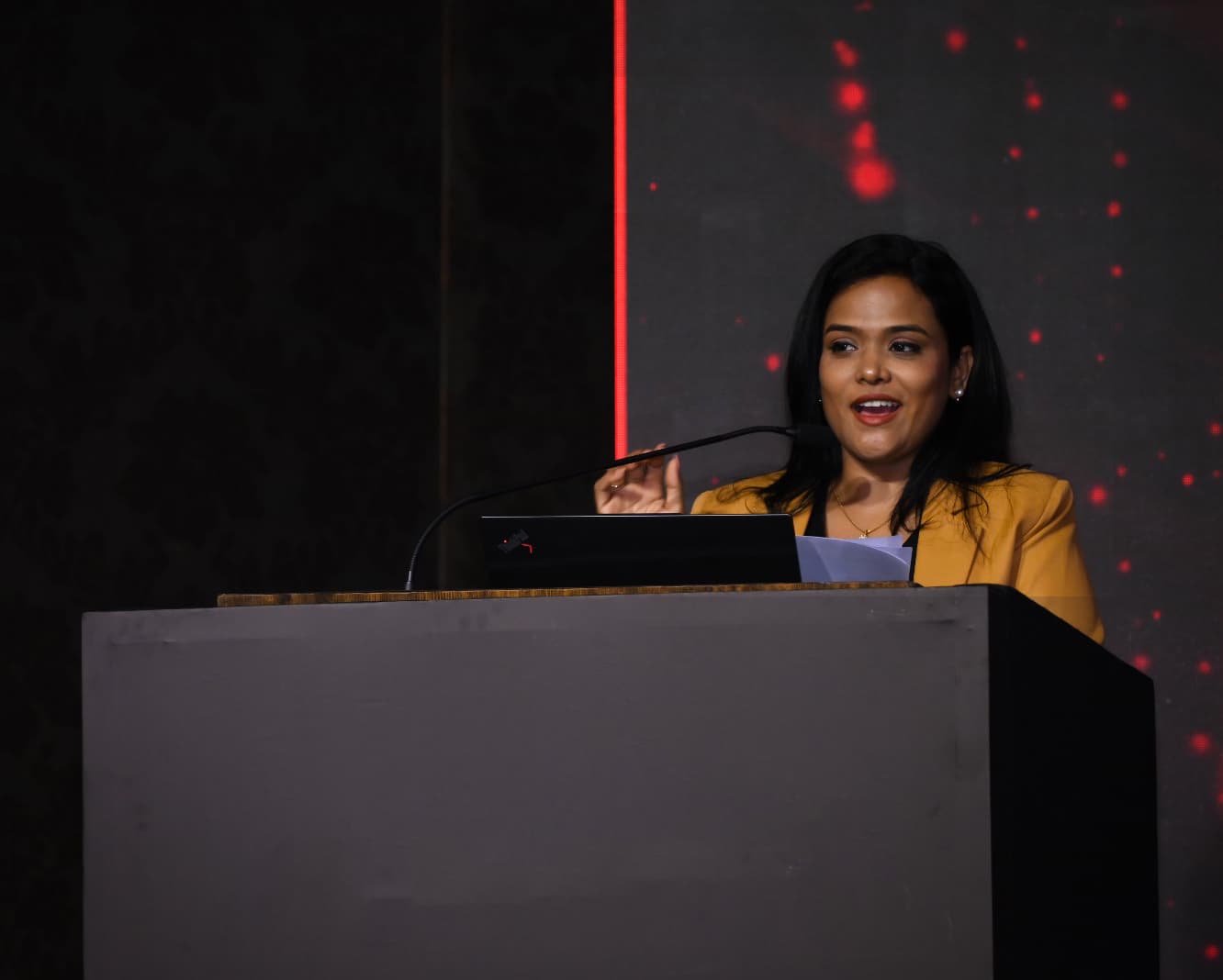 Devaki speaking on stage at The Empowher Journal event